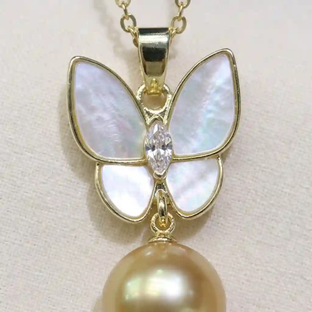 butterfly fringe necklace - Extreme macro close-up of MIRAMETAL ML-0970 showing the iridescent mother-of-pearl texture on the butterfly wings, the marquise-cut zircon center, and t
