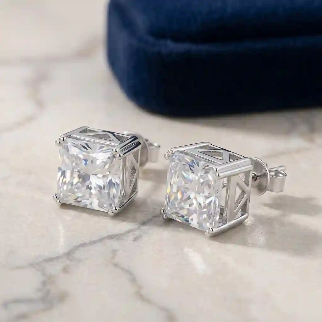 moissanite stud earrings - Key: Large 4x6 ft softbox 45° left; Fill: White foam core reflector 30° right; Rim: Strip box from behind for metal edge definition; 5600K daylight balan