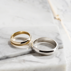 Sterling silver ring stamped 925 next to silver-plated ring showing visible plating wear, side-by-side comparison