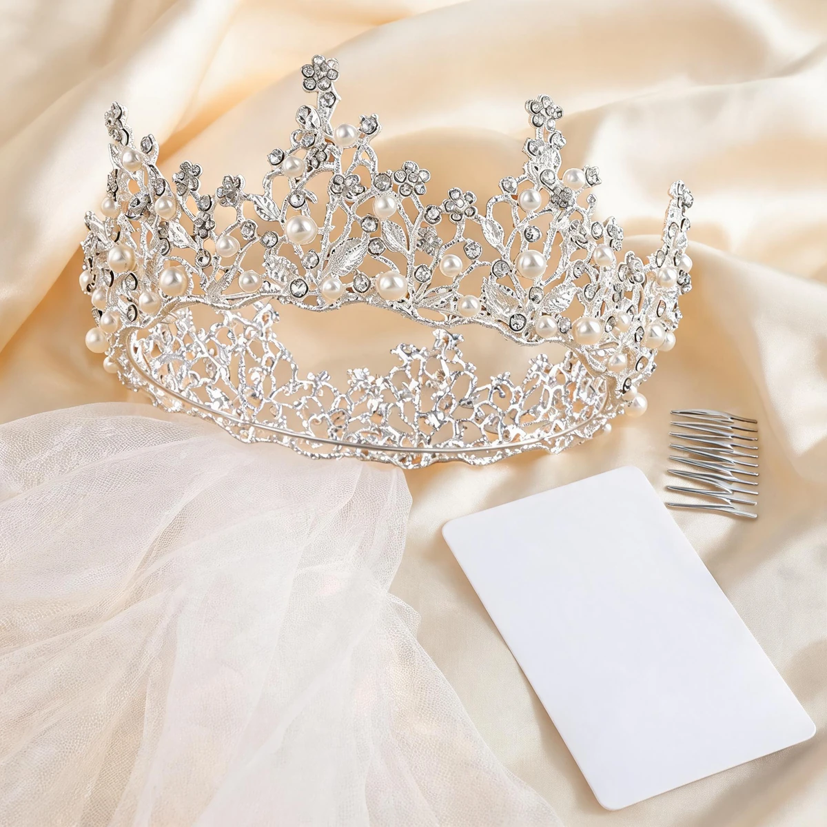 round Baroque crown styling flat lay with ivory veil