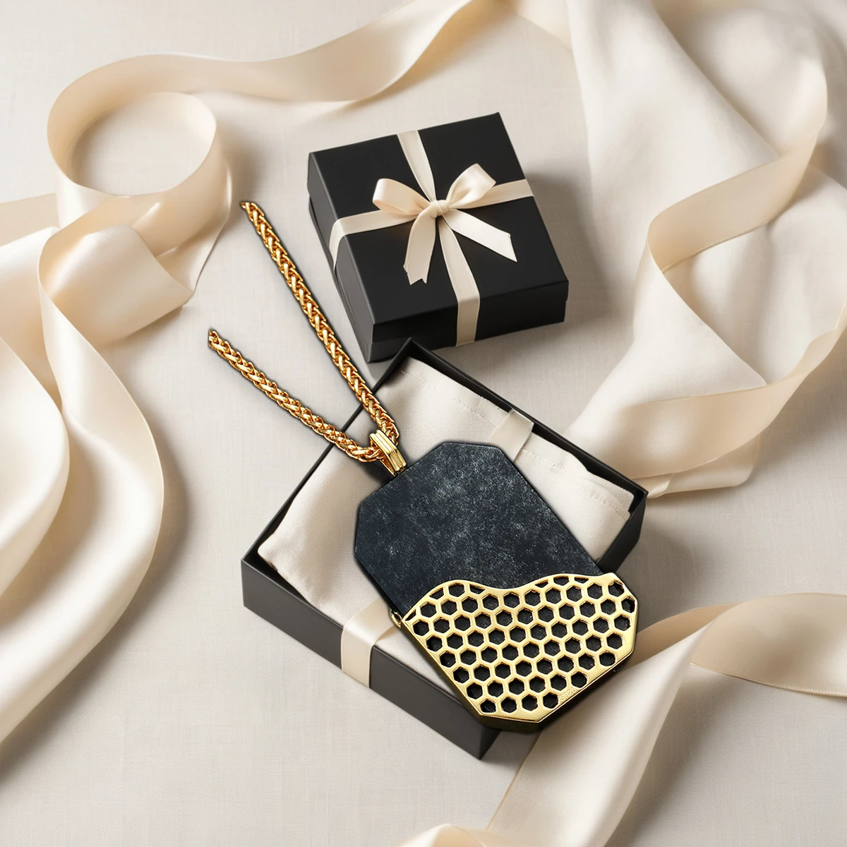 Black obsidian pendant with premium black and gold jewelry packaging