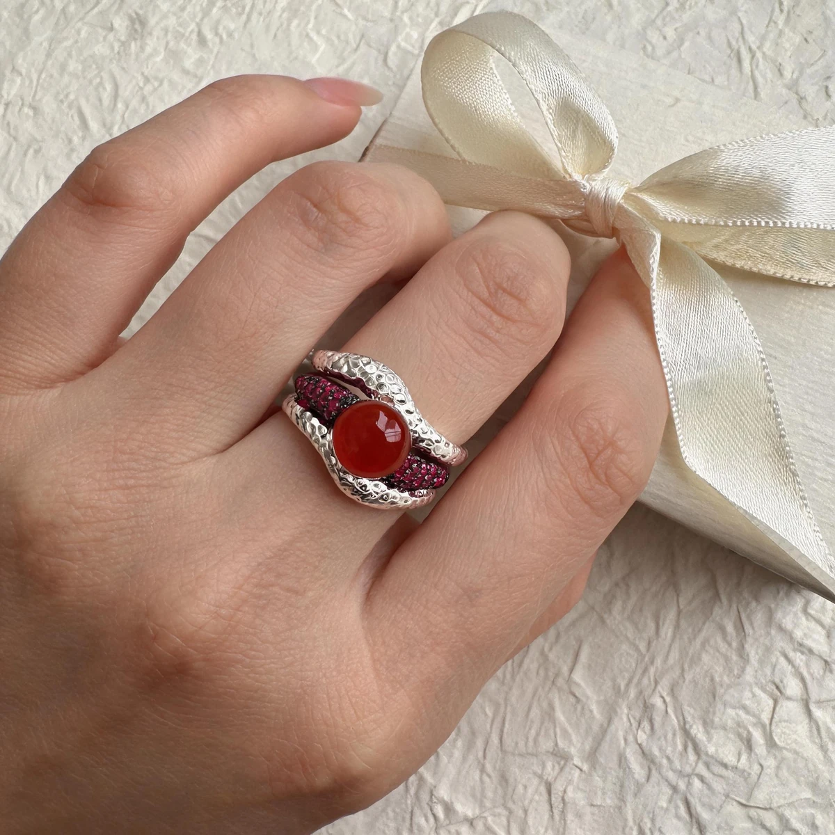Woman wearing a natural gemstone statement ring in 925 silver