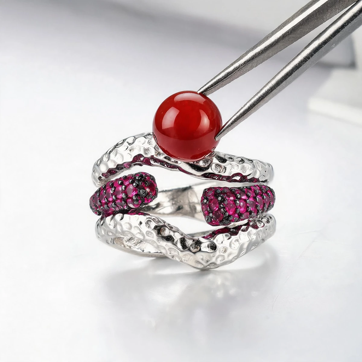 Jeweller setting a natural gemstone into a 925 silver crossover ring band