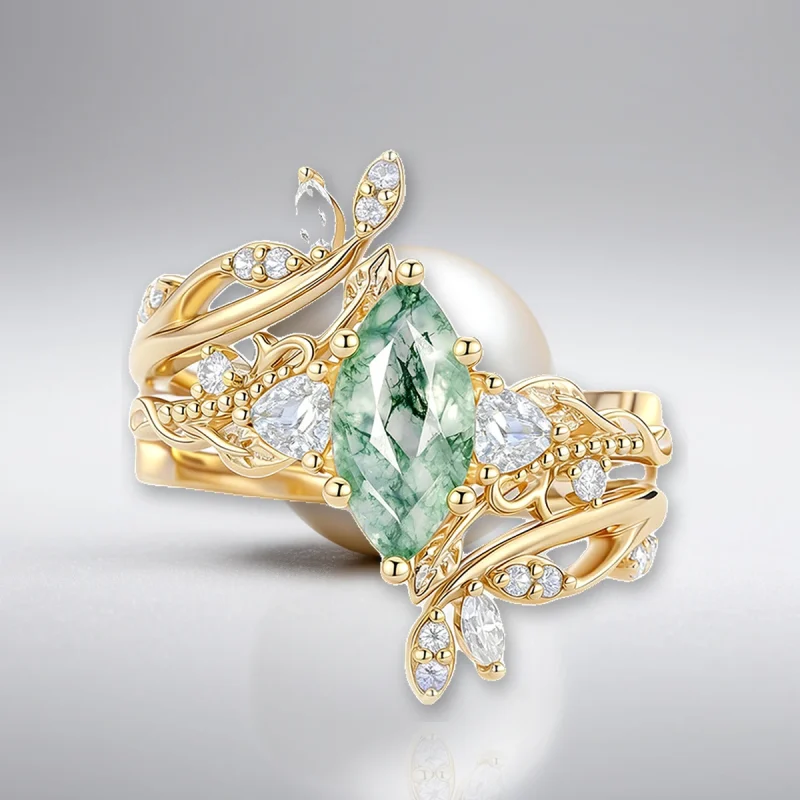 Moss agate ring set in gold tone 925 silver on pearl white studio background