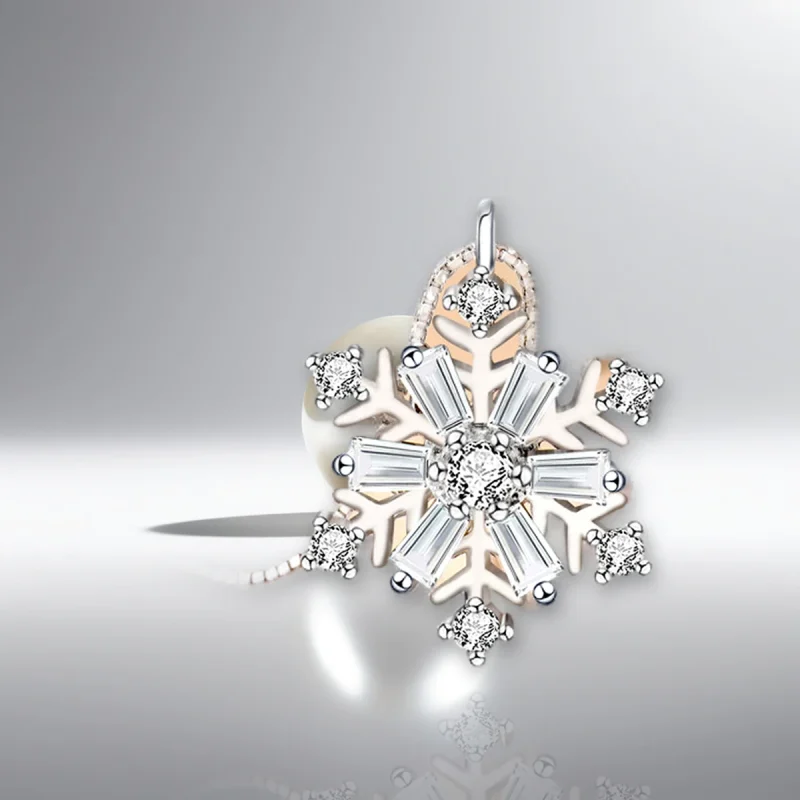Rotating snowflake necklace in 925 sterling silver on pearl white studio background