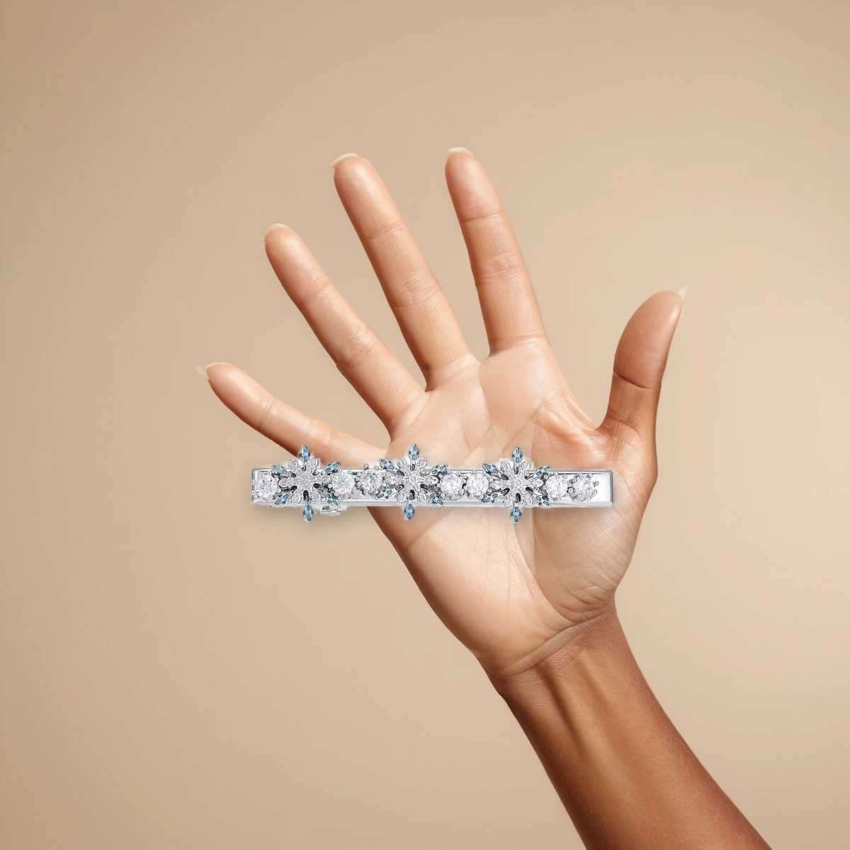 Crystal snowflake hair clip held in hand for scale