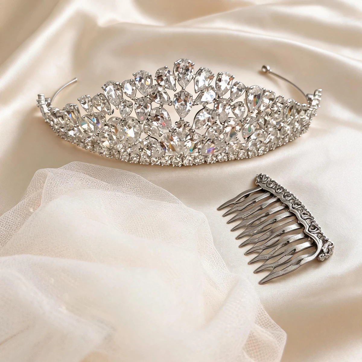 sparkling crystal crown tiara bridal styling flat lay with ivory veil