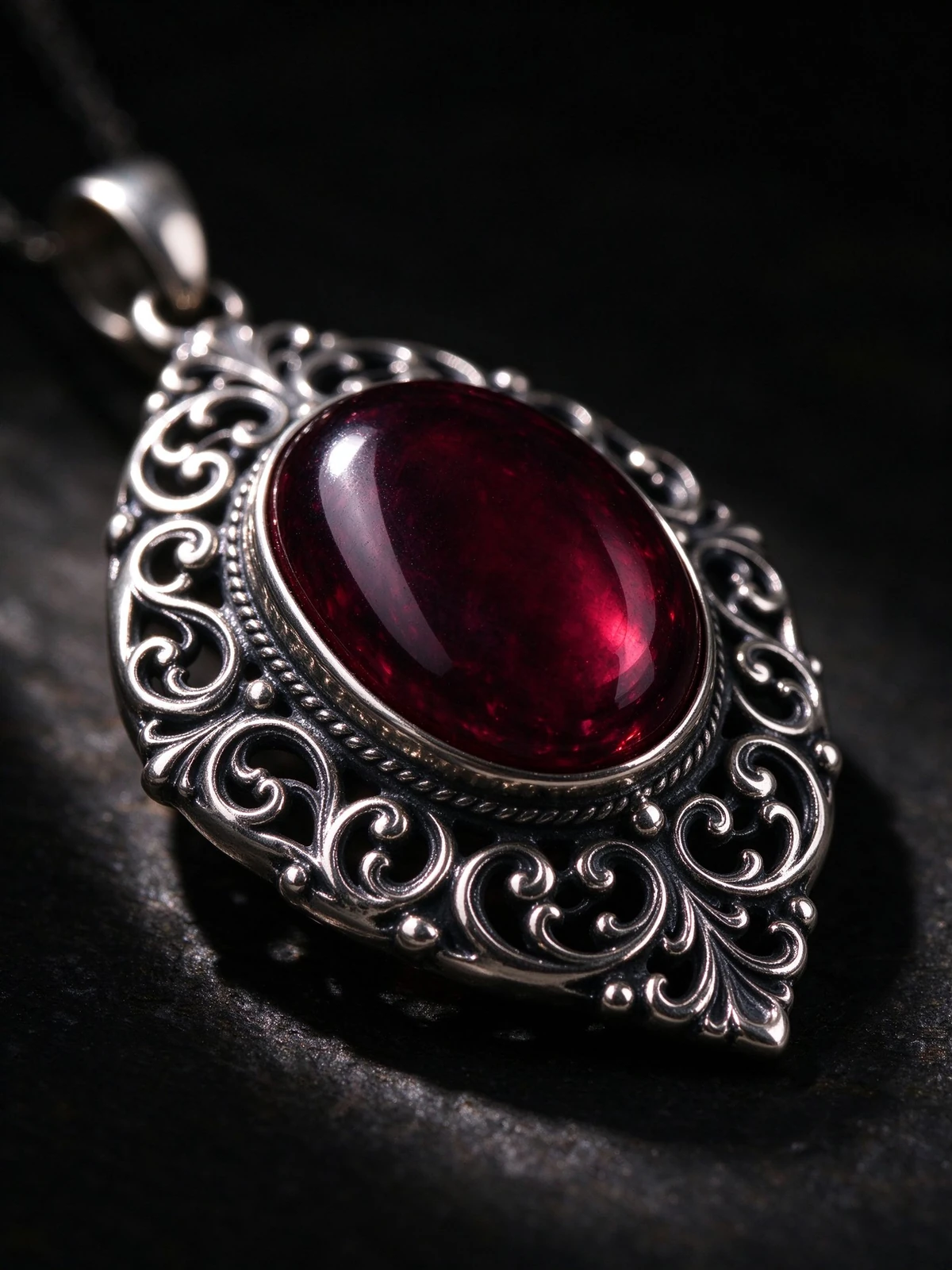 Craftsmanship macro of garnet pendant necklace silver filigree