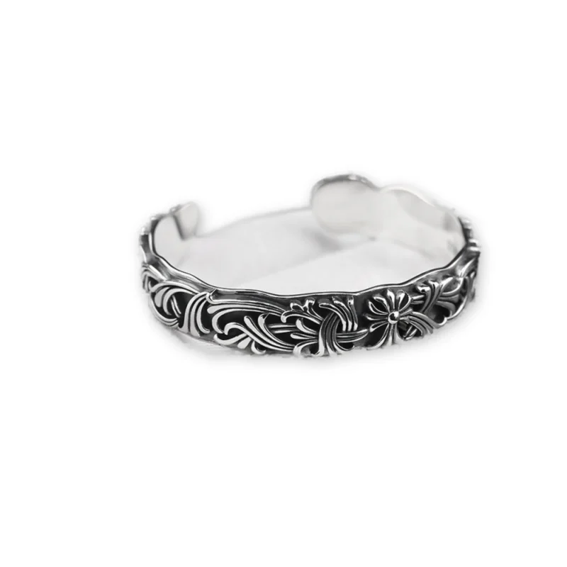 Oxidized 925 sterling silver cuff bracelet with Gothic scrollwork on a white background