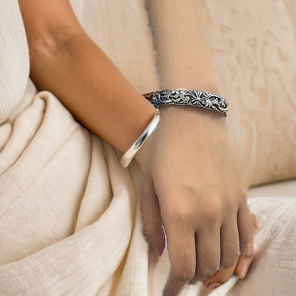 Woman wearing the oxidized silver cuff bracelet with a cream sleeve