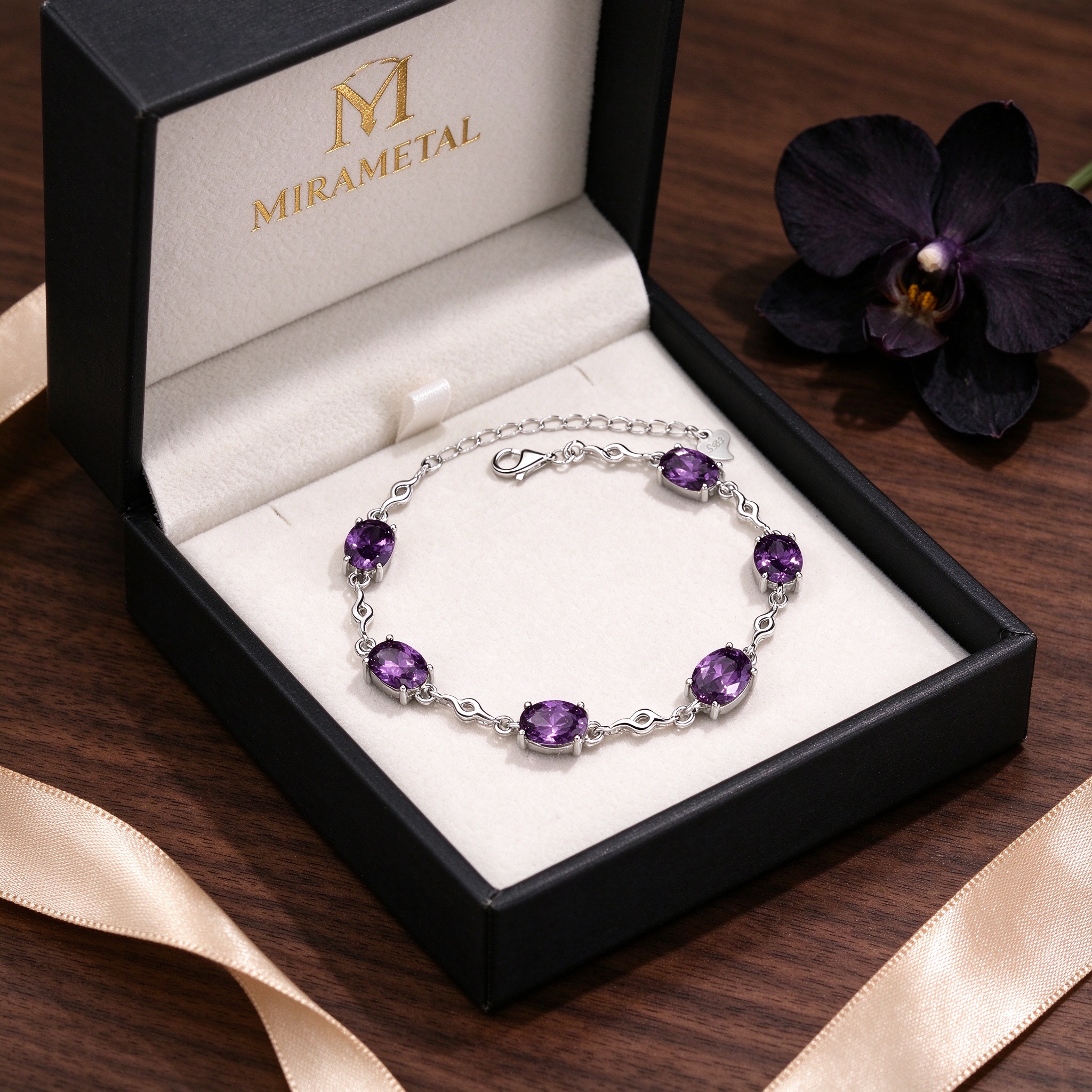 Amethyst bracelet in open black MIRAMETAL gift box with gold foil logo