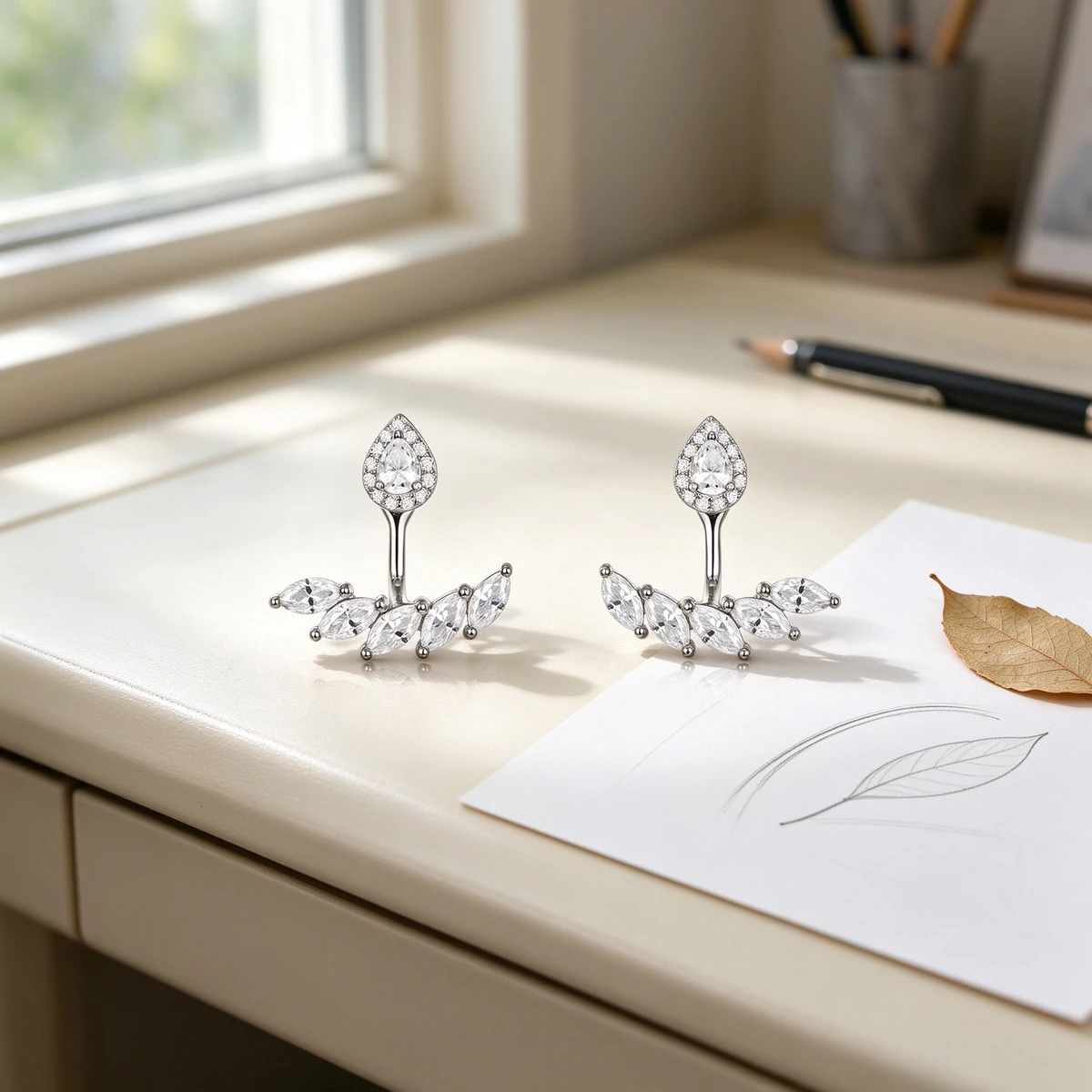 Teardrop moissanite earrings design story with pear halo and marquise jacket