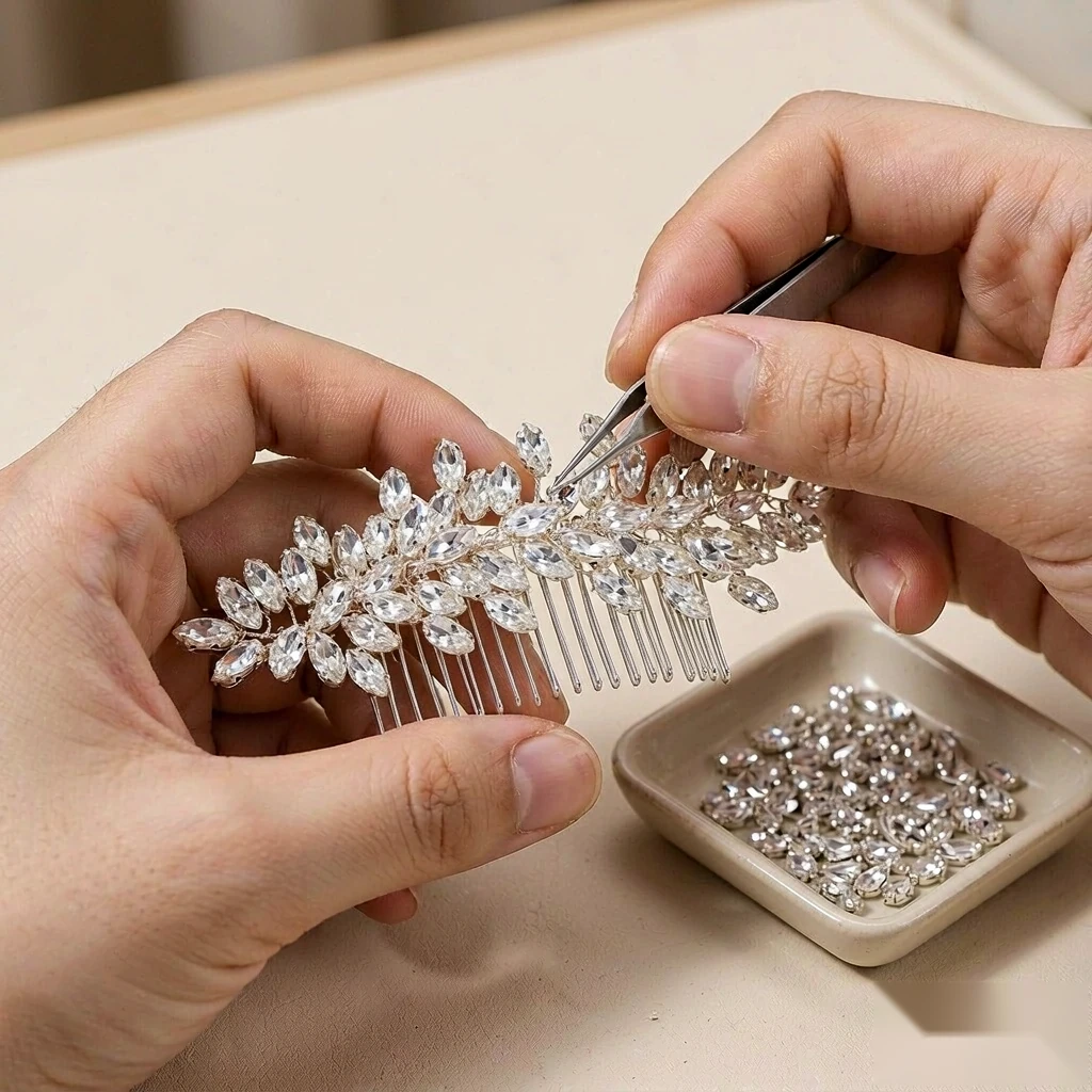 Artisan hands setting marquise crystals onto a silver bridal hair pin
