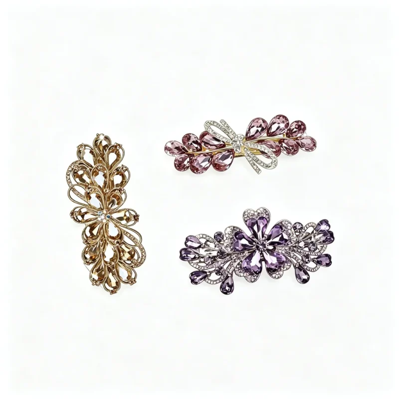 Set of three crystal floral hair clips in gold and purple on pure white background