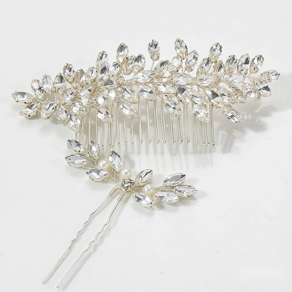 Macro close-up of marquise-cut crystal leaves and silver wire on a bridal hair comb