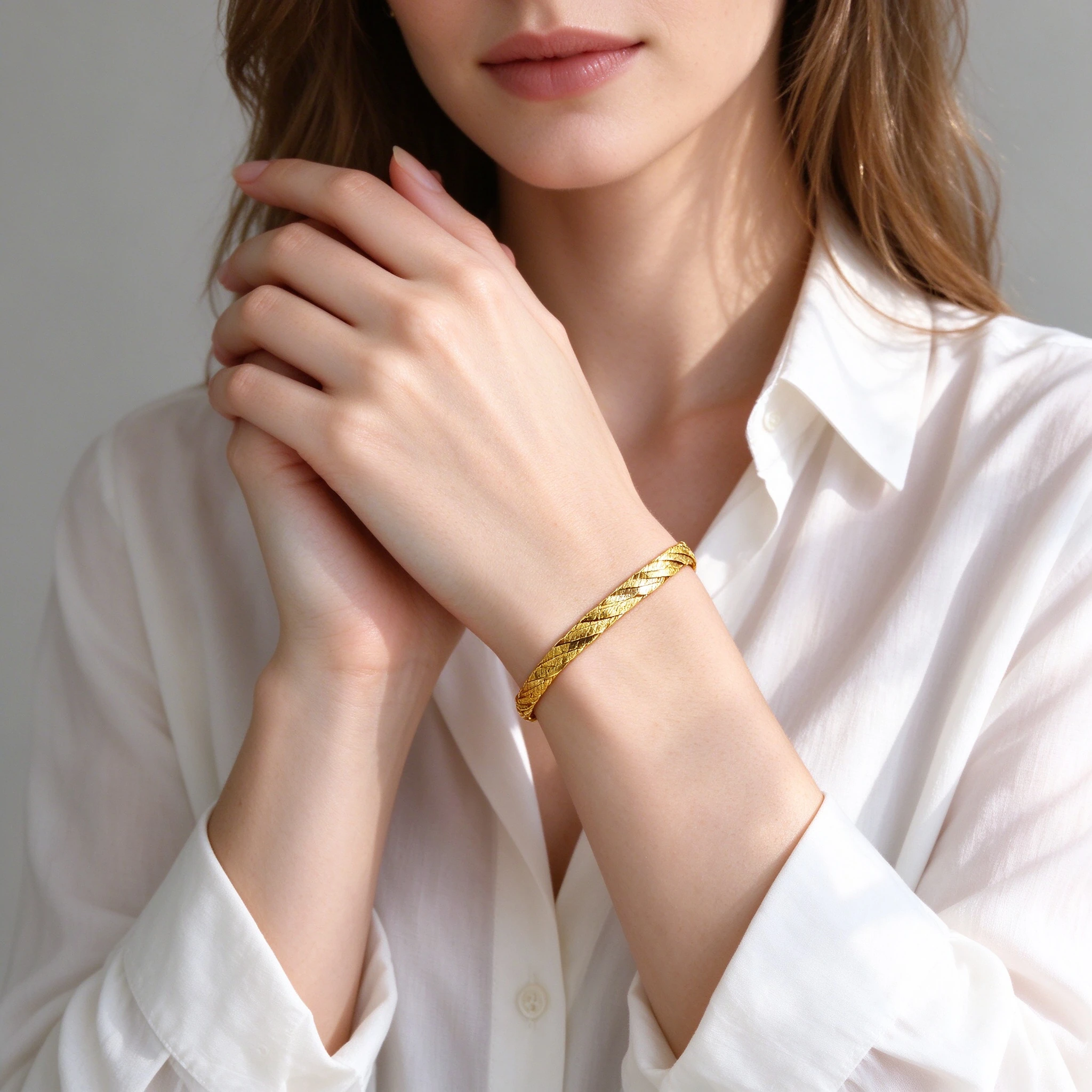 Woman wearing triple strand braided bracelet with white shirt