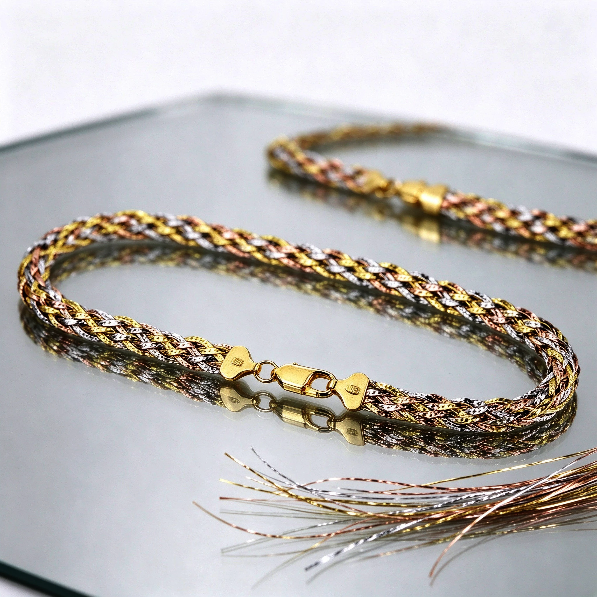 Material close-up of the braided silver necklace — mirror-polished tri-color plating and 925 stamp